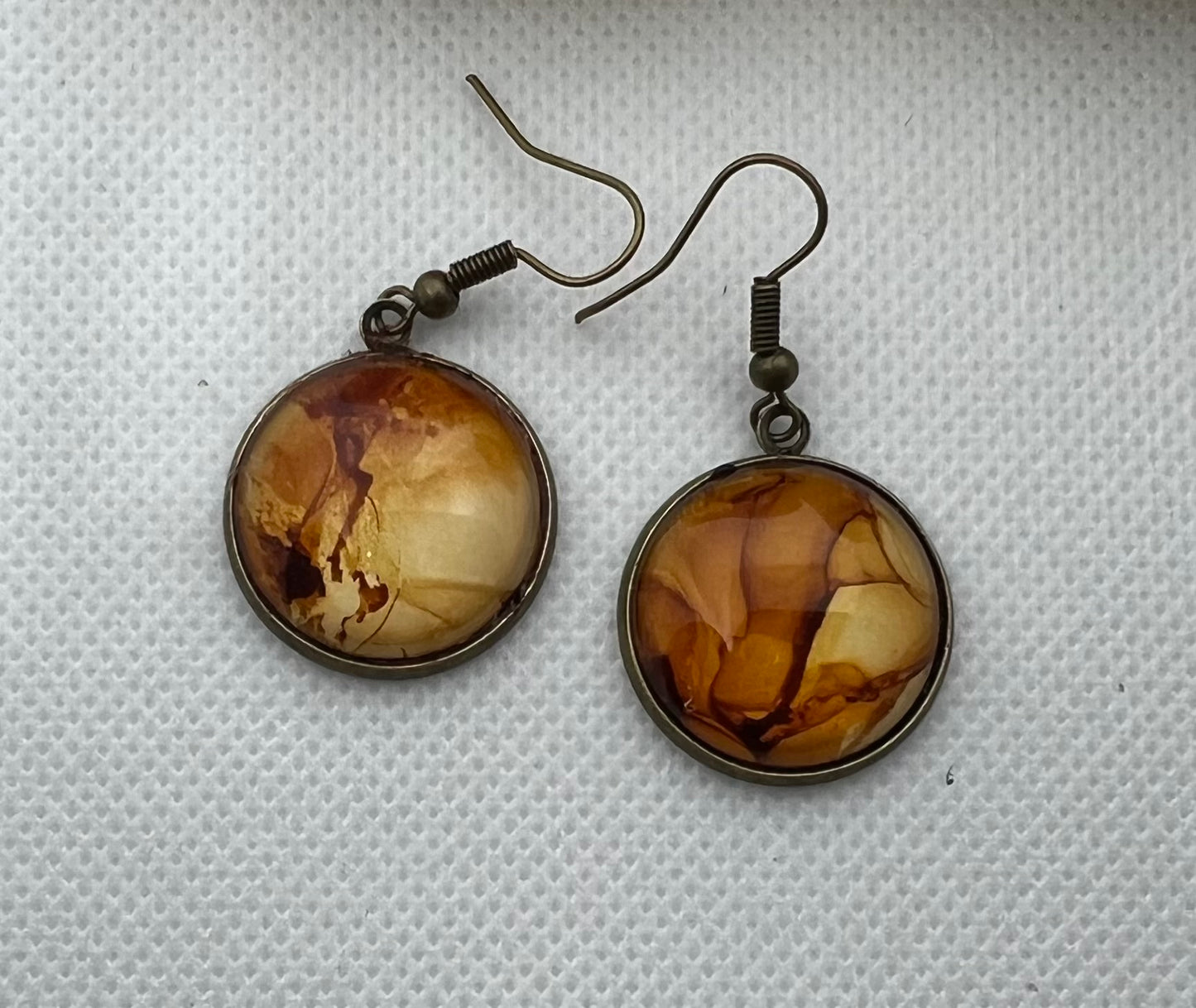 E25-043 Rockin' Cliffs Alcohol Ink Painting in brass setting with glass cabochon